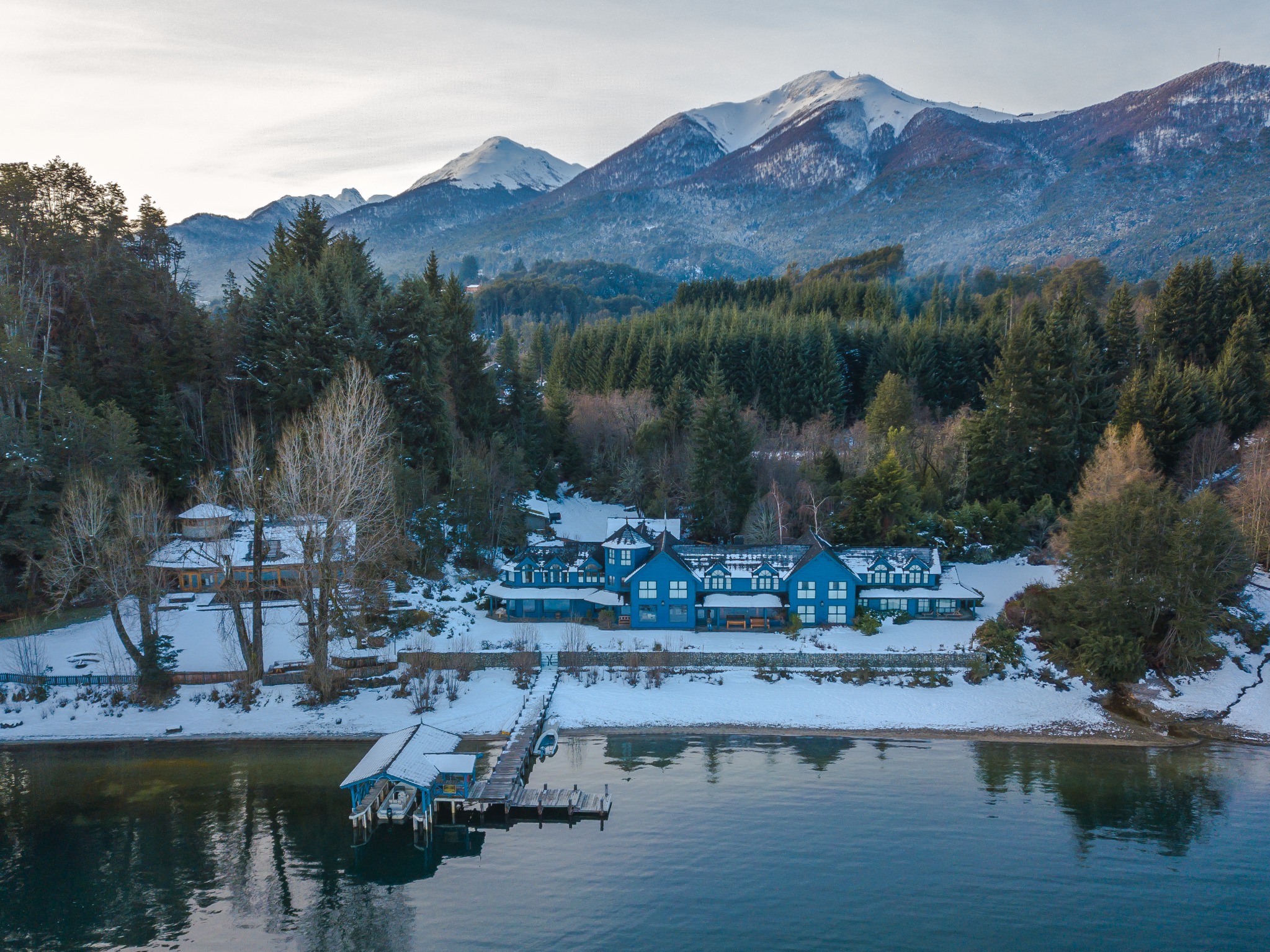 Hotel de montaña en invierno con montañas patagónicas de fondo